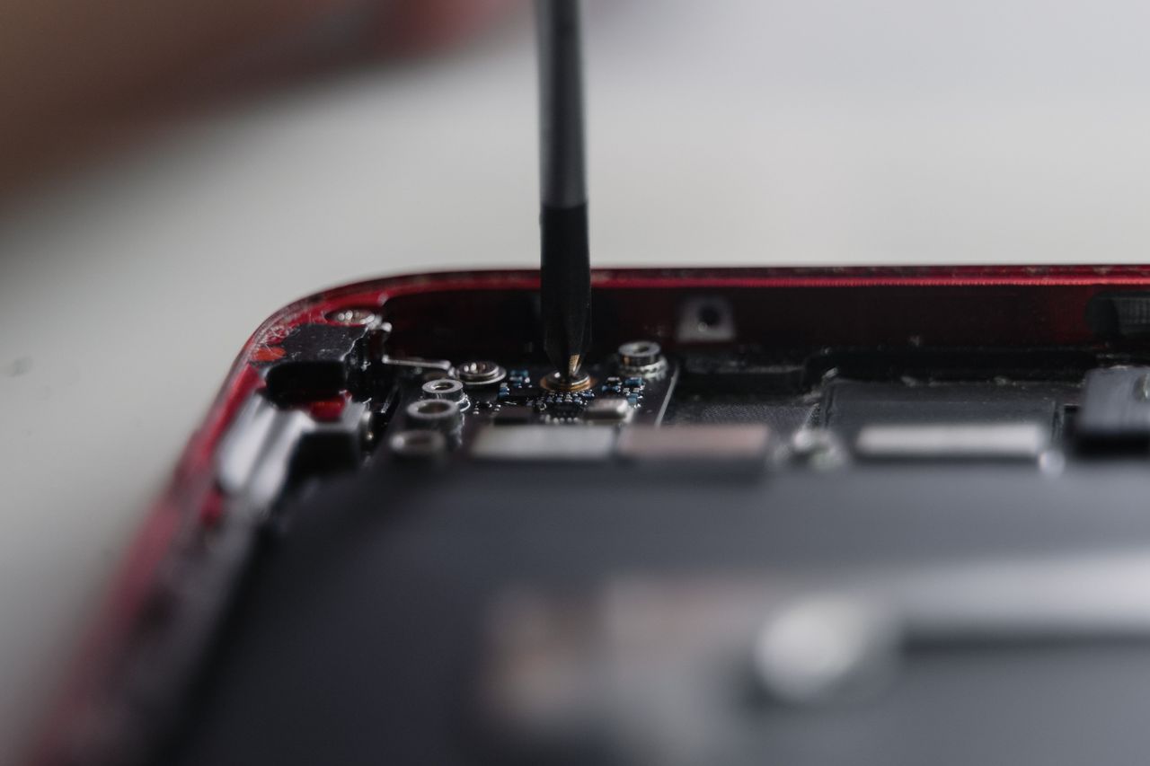 Crafting Captivating Headlines: Your awesome post title goes here Professional repair of a smartphone's internal components using precise tools.
